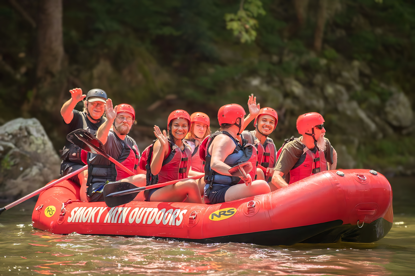 white water rafters waving from raft