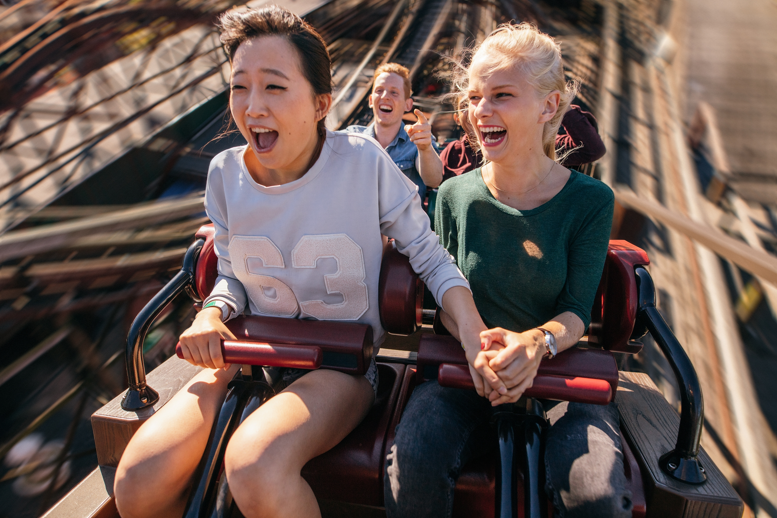 two women riding roller coaster