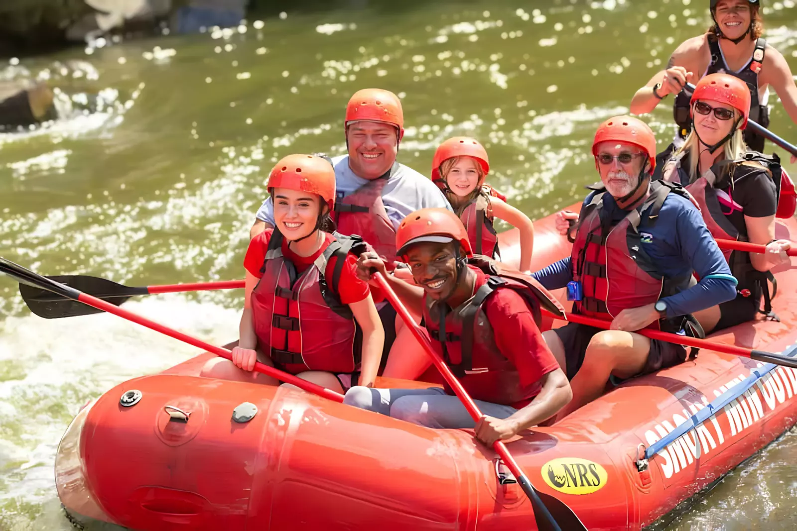 smiling rafters on white water raft