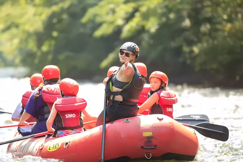 guide pointing back from raft