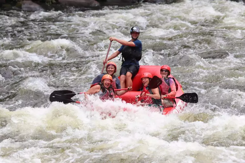 whitewater raft in rapids getting splashed with lots of water