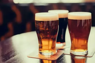 Glasses,Of,Light,And,Dark,Beer,On,A,Pub,Background.