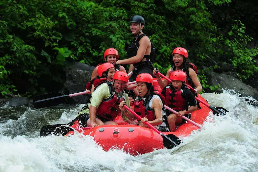 A family white water rafting with Smoky Mountain Outdoors.