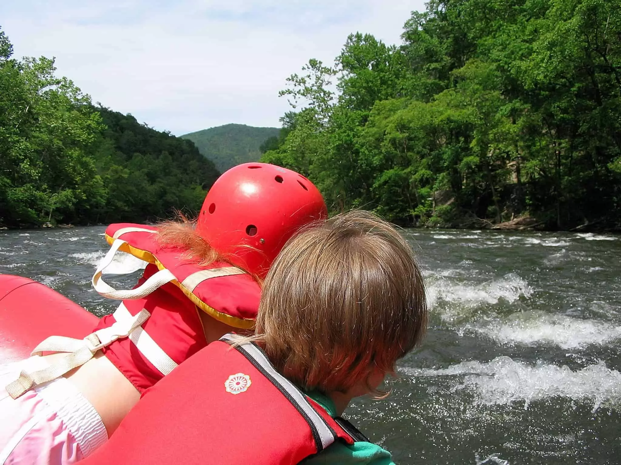Young girl and brother looking at waves while rafting on Lower Pigeon River in Smoky Mountains