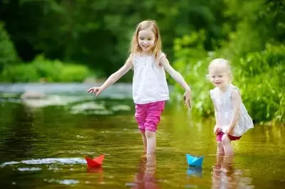 two sisters playing in the Little Pigeon River