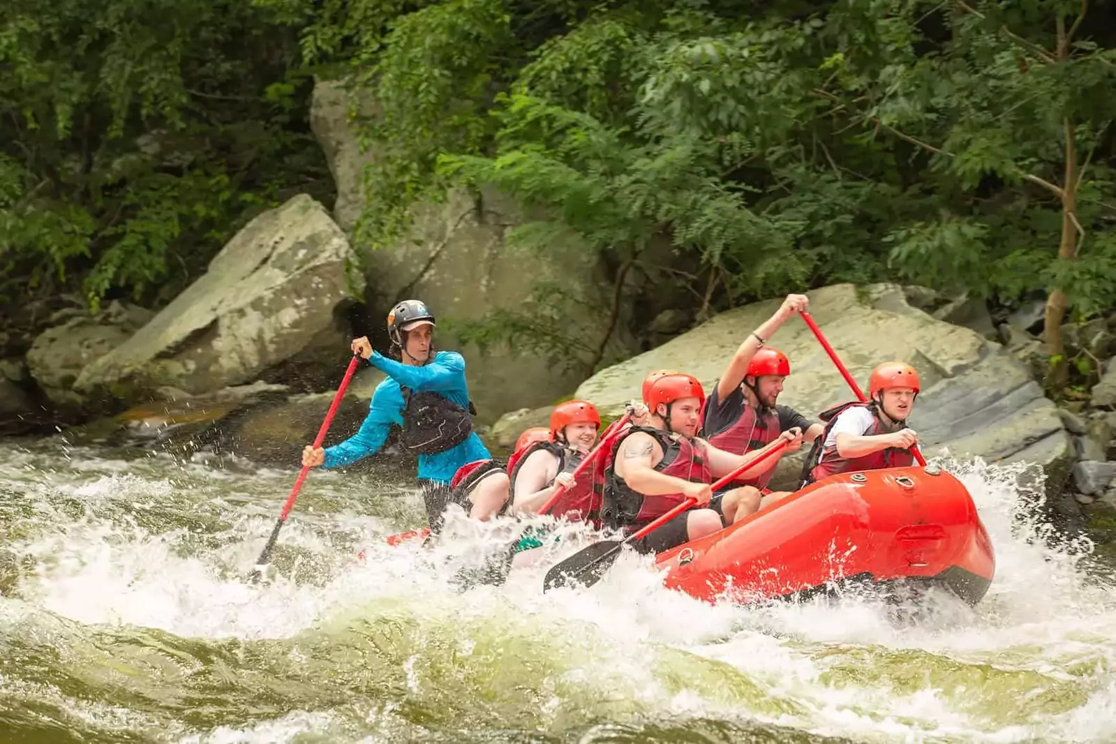 raft going over white water rapids