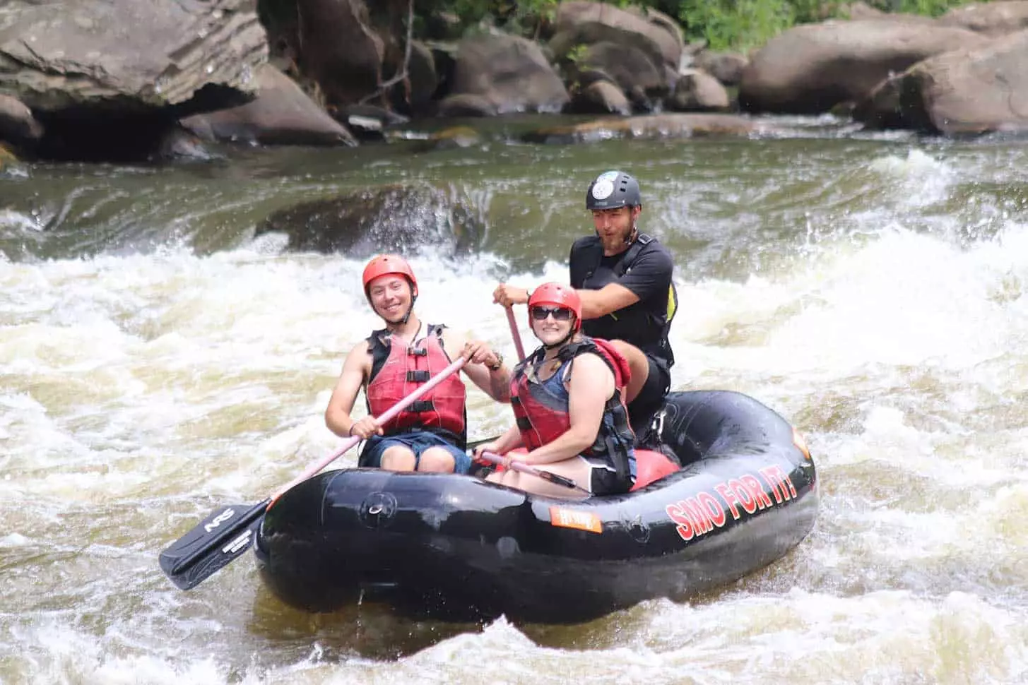 smiling man and woman on guided Extreme Upper River Rafting trip