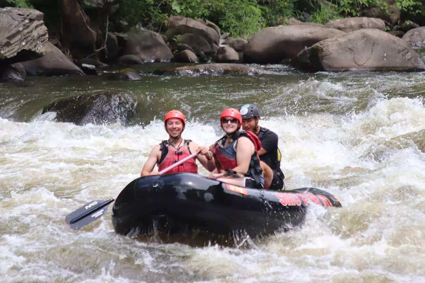 man and woman with guide on Extreme Upper River Rafting rapids