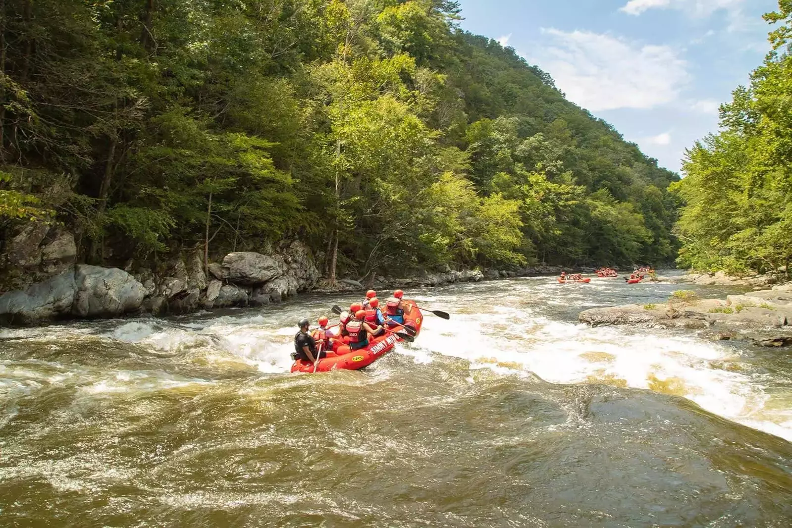 whitewater raft going over rapids