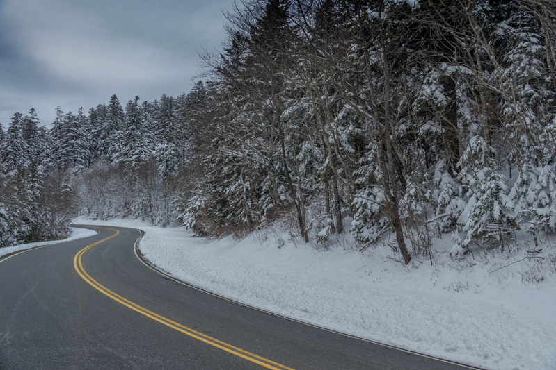 winding road in the Smoky Mountains surrounded by snow