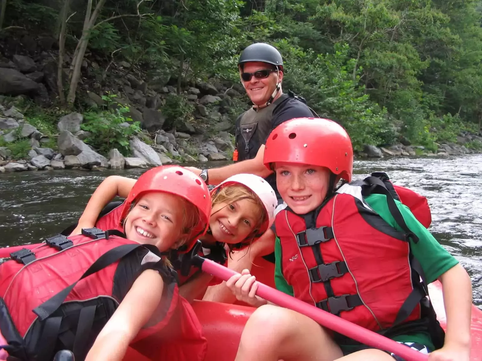 smiling kids in a raft