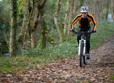 A man mountain biking, one of the best outdoor Smoky Mountain activities in the fall.