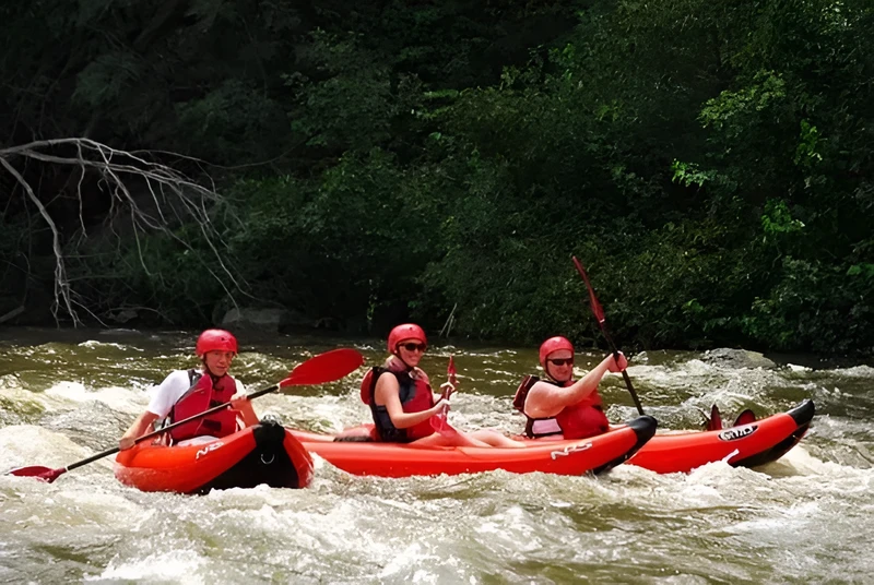 Three happy people having fun on a Smoky Mountain kayaking trip