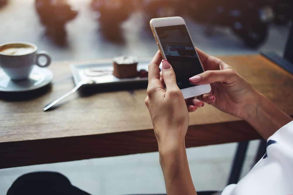 woman scrolling on her cell phone