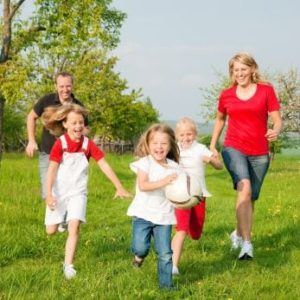 active family running in grass