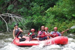 family and guide rafting in inflatable raft