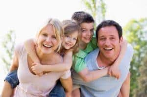 family laughing piled up outdoors