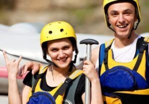Young couple preparign to go white water rafting