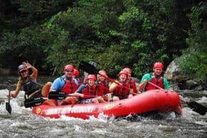 White water rafint group waving to the camera