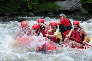 People smiling while white water rafting