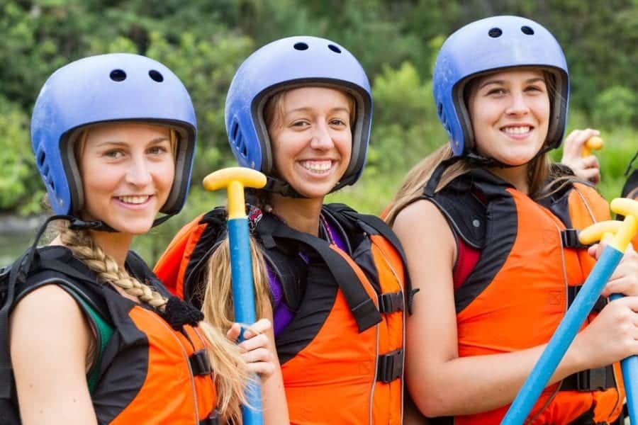 Young women smiling before white water rafting in the Smoky Mountains