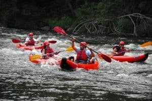 Family kayaking in Gatlinburg, one of the most popular things to do in the Smoky Mountains.