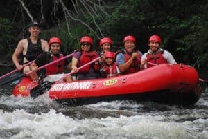 Family posing for a picture while white water rafting near Pigeon Forge