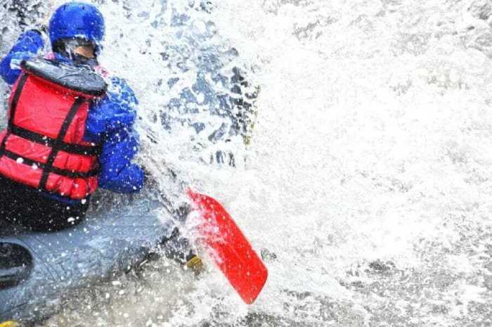 rafter getting splashed with water on river