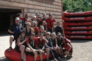 A family reunion group posing for a photo after an afternoon of Smoky Mountains white water rafting.