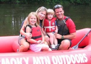 Family on red Smoky Mountain Outdoors raft near Gatlinburg TN