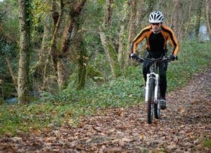 A man mountain biking, one of the best outdoor Smoky Mountain activities in the fall.