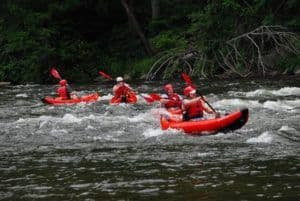 A group of people enjoying a Smoky Mountain kayaking trip.