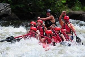 A rafting guide with a big group having fun Upper Pigeon River rafting.