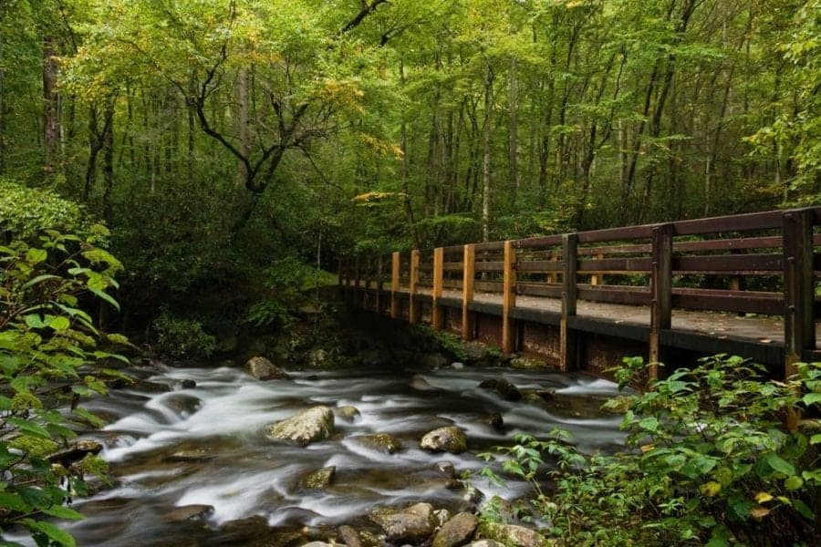 Smoky Mountain hiking trail bridge over a peaceful stream