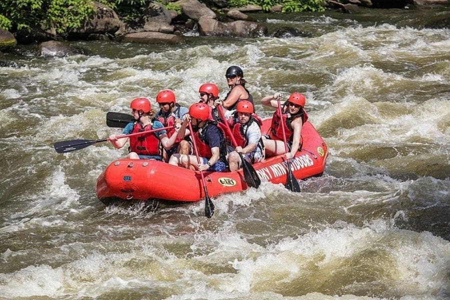 A group of people enjoying Smoky Mountain whitewater rafting.