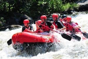 A group of people river rafting in the Smokies.