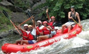 Excited family enjoying rafting with Smoky Mountain Outdoors