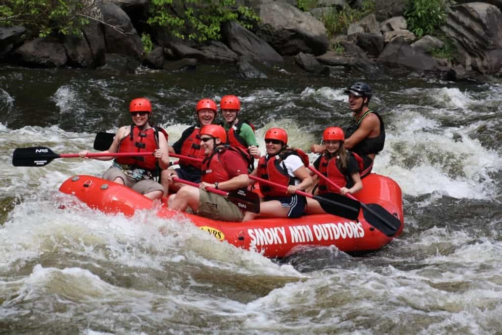 Group of people enjoying whitewater raft trip