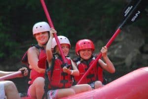 Excited young children on rafting trip