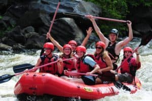 Excited group of people on a rafting trip