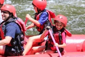 girl paddling on a raft