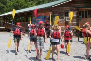 people walking with paddles