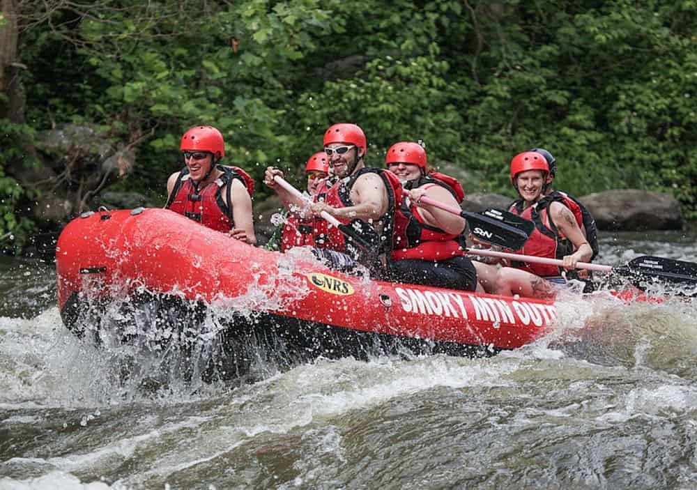 group of people white water rafting