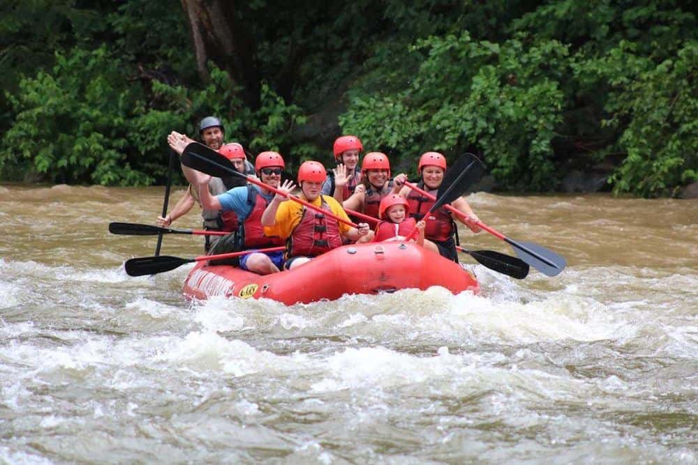 group of people white water rafting in the smoky mountains