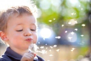 close up of child playing with bubbles