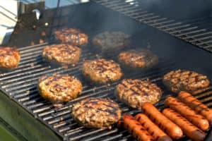 burgers and hot dogs on a grill