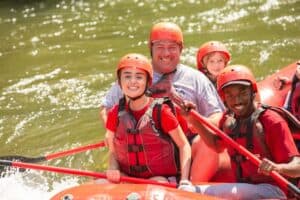 dad and daughter white water rafting in the Smoky Mountains