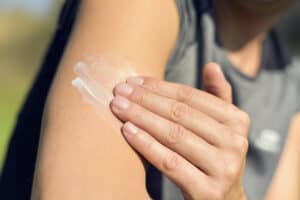 applying sunscreen on arm