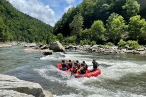Smoky Mountain Outdoors raft navigating rapid on Pigeon River