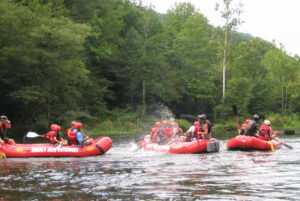 group of rafts having splash battle on Pigeon River